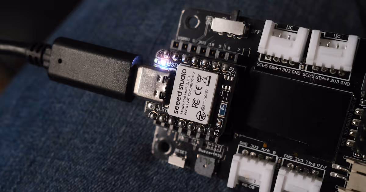 Seeed Studio XIAO-nRF52840 with all LEDs lit.